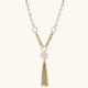 Long gold-plated necklace with freshwater pearls, chunky chain links, and flowing tassel pendant